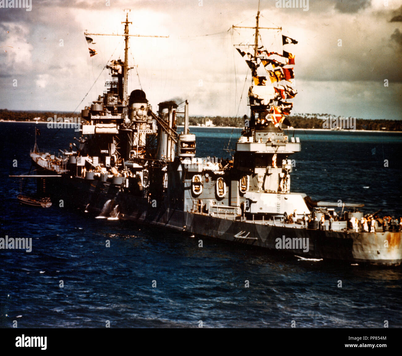 USS Quincy (CA-39) Photographed from USS Wasp (CV-7), at Noumea, New Caledonia, on the eve of the invasion of Guadalcanal, 3 August 1942. She was sunk six days later, during the Battle of Savo Island. Note Quincy's signal flags and Measure 12, Modified, camouflage scheme. Stock Photo