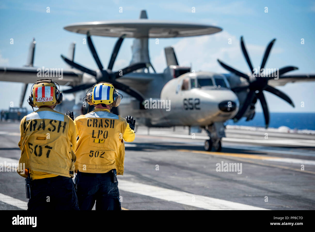 180917-N-SO730-0064 ATLANTIC OCEAN (Sept. 17, 2018) Aviation Boatswain's Mate (Handling) 1st Class John Back, right, from Jackson, New York, under the direction of Aviation Boatswain's Mate (Handling) 2nd Class Ismael Gabriel Gonzales, from Newburgh, New York, spots an E-2C Hawkeye, assigned to Carrier Airborne Early Warning Squadron (VAW) 124, during flight operations aboard the aircraft carrier USS George H.W. Bush (CVN 77). GHWB is underway in the Atlantic Ocean conducting routine training exercises to maintain carrier readiness. (U.S. Navy photo by Mass Communication Specialist 3rd Class J Stock Photo
