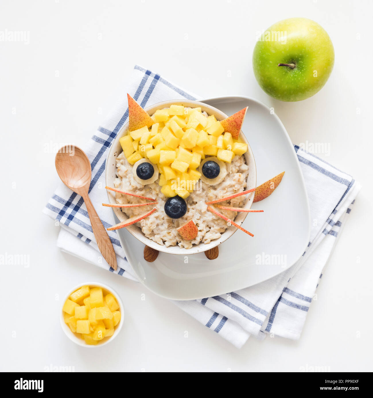 Healthy breakfast oatmeal porridge for kids. Funny creative food art for kids. Cute fox made with fruits and berries on oatmeal porridge. Top view Stock Photo