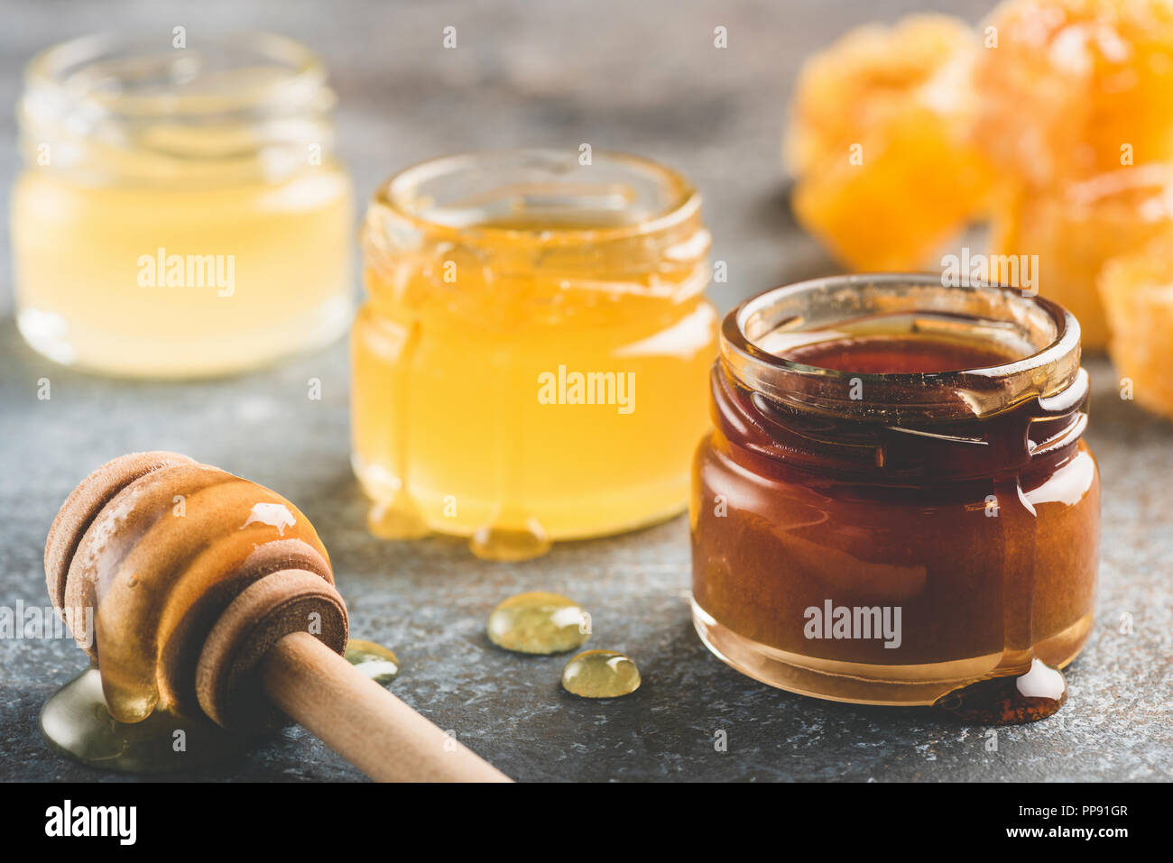 Selection of honey in small honey jars. Closeup view, toned image Stock Photo