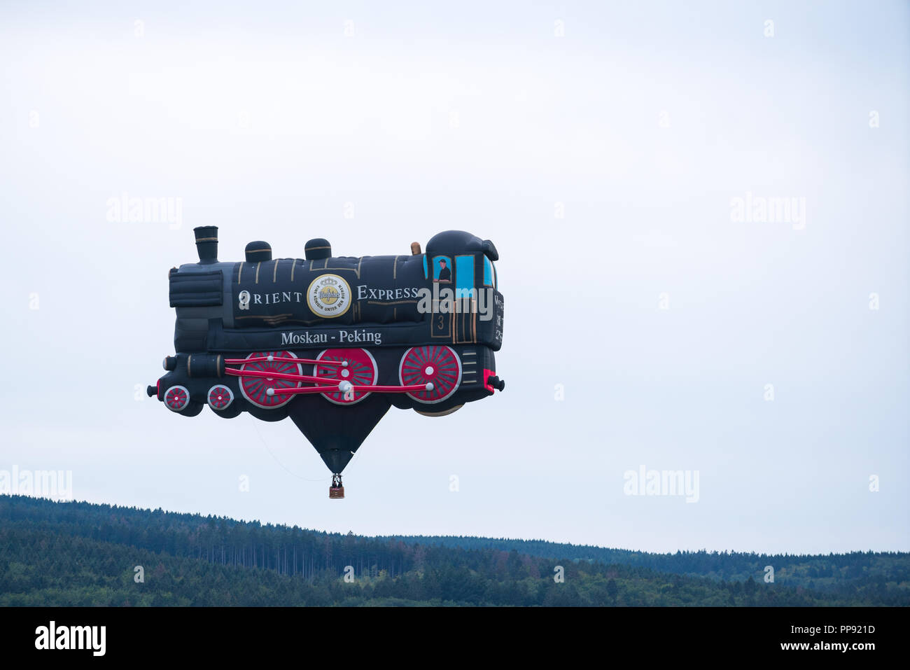 Flying railway engine at the 28th Warsteiner Internationale Montgolfiade, 2018 in Warstein, Germany, during the last mass start of the WIM Stock Photo