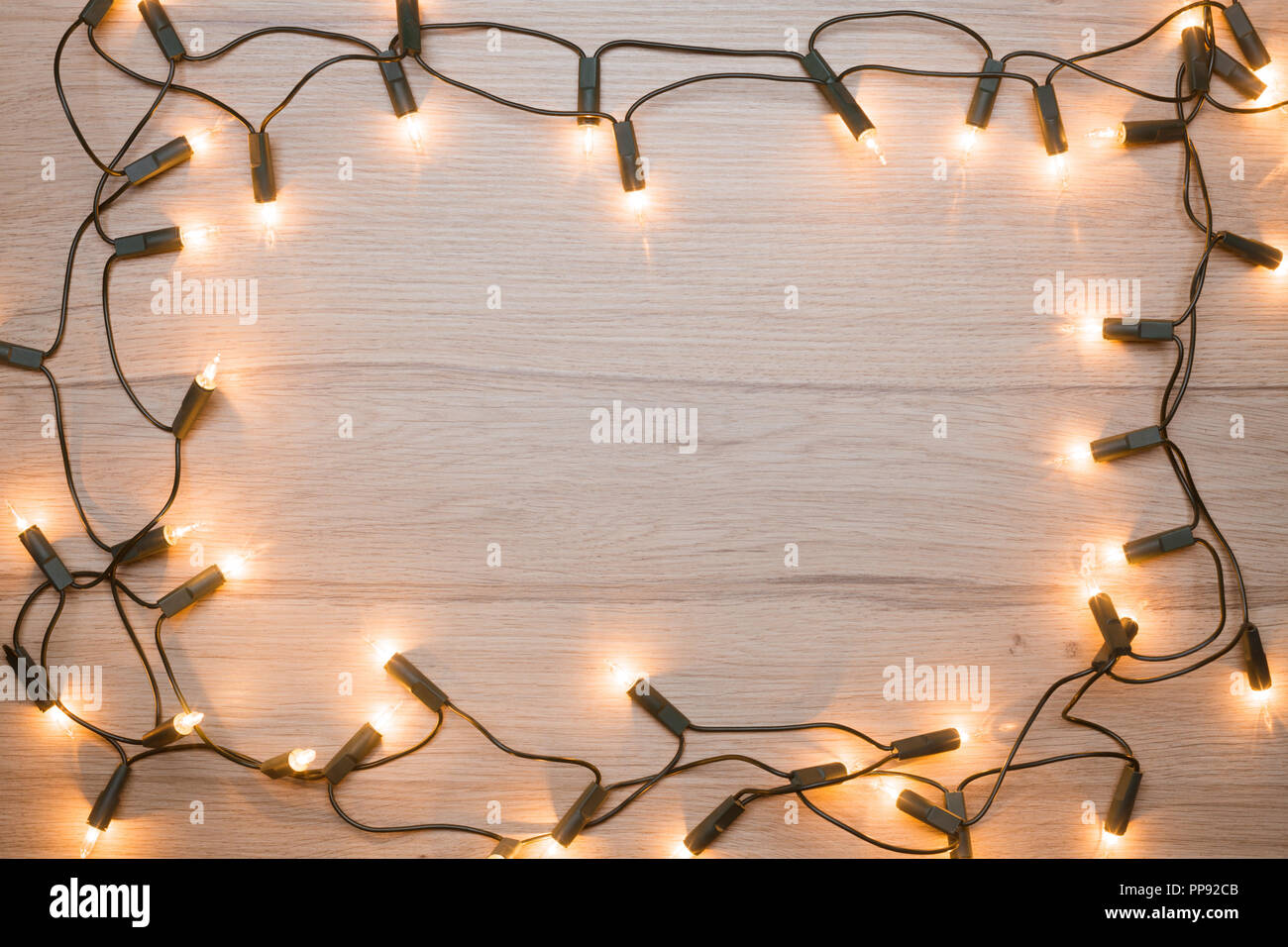 Christmas lights frame on a wood Stock Photo Alamy