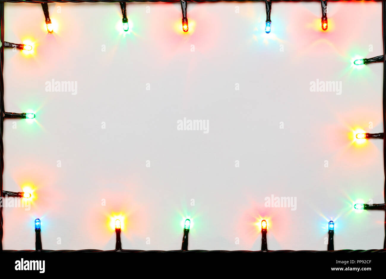 Christmas Lights Of Different Colors Frame On White
