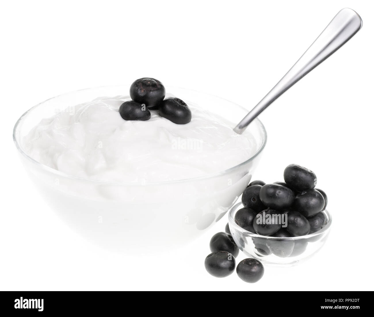 Yogurt bowl with spoon and Blueberries on white background Stock Photo