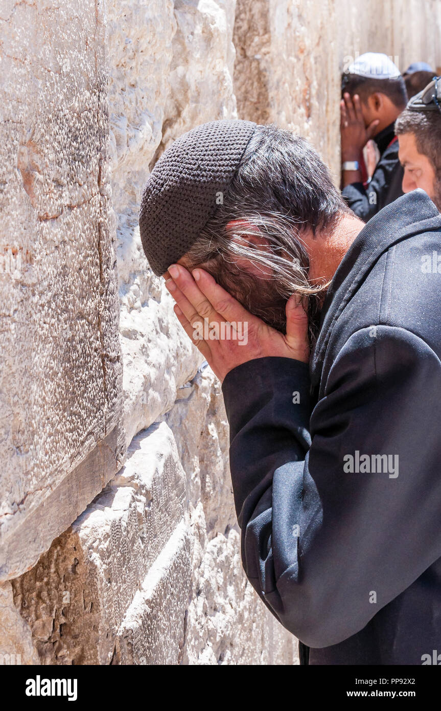 Jerusalem, Israel - April 29, 2014: Jewish Orthodox man praying with a lot of energy and strong emotions near the stones of the Western Wall. Western  Stock Photo