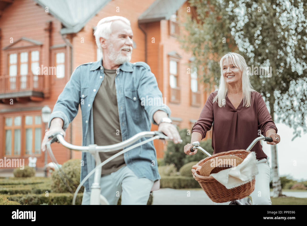 Cheerful senior people enjoying the nature on bikes Stock Photo