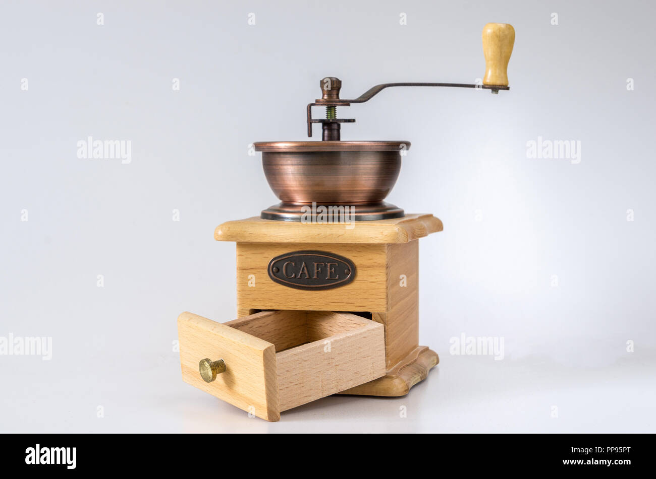 https://c8.alamy.com/comp/PP95PT/decorative-hand-wooden-grinder-on-the-roasted-coffee-PP95PT.jpg