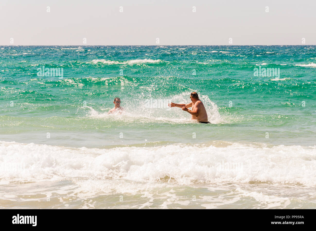 Here you can see a two young men play in the water, pour each other in the  Mediterranean Sea Stock Photo - Alamy