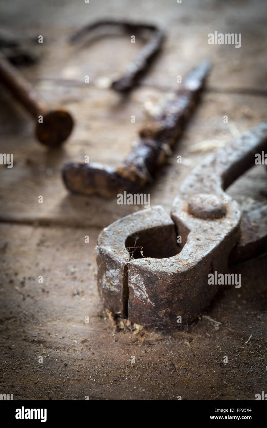 Old rusty tools in the workshop on an old wooden table Stock Photo