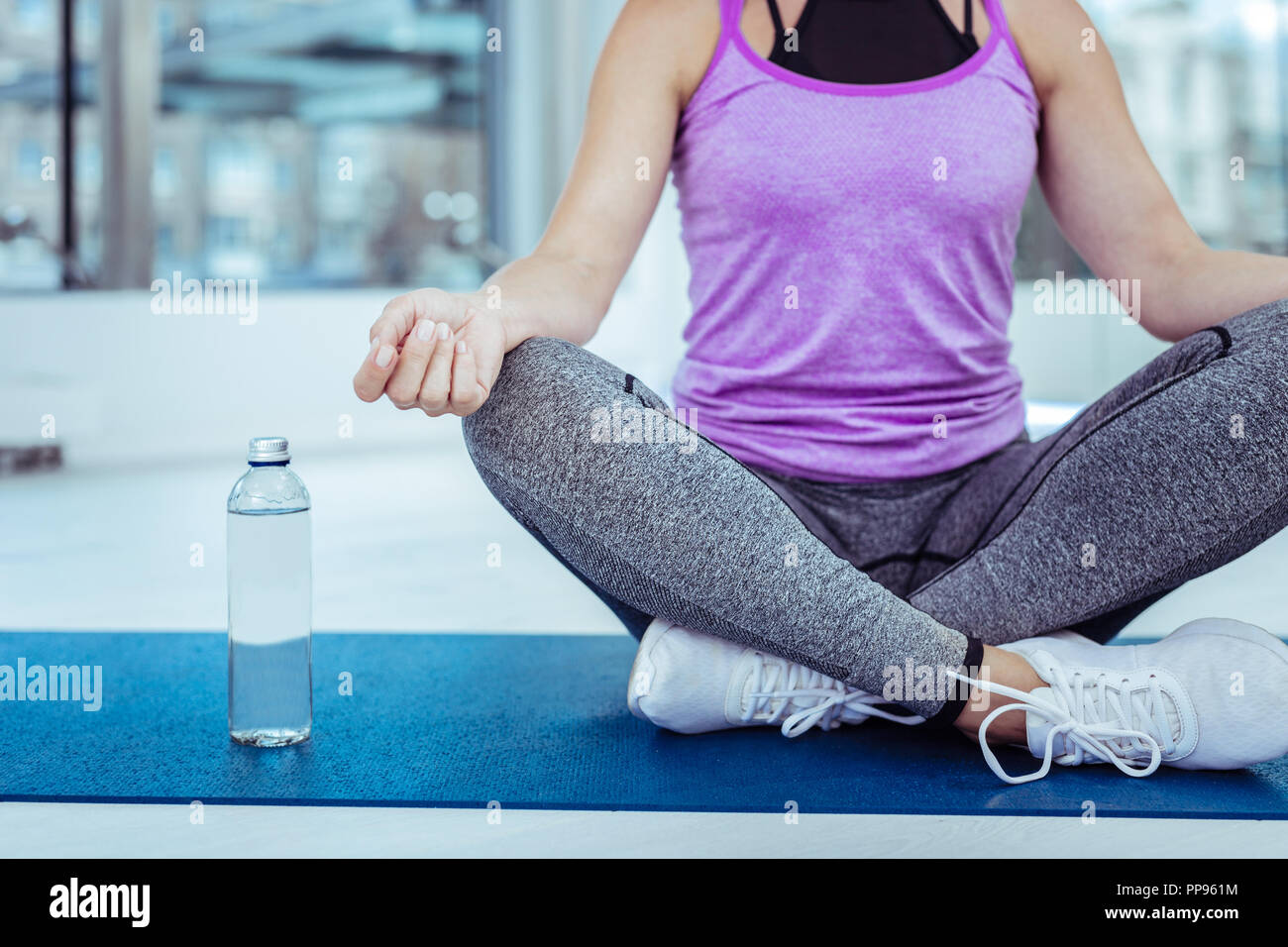 Nice young female hands lying on knees Stock Photo