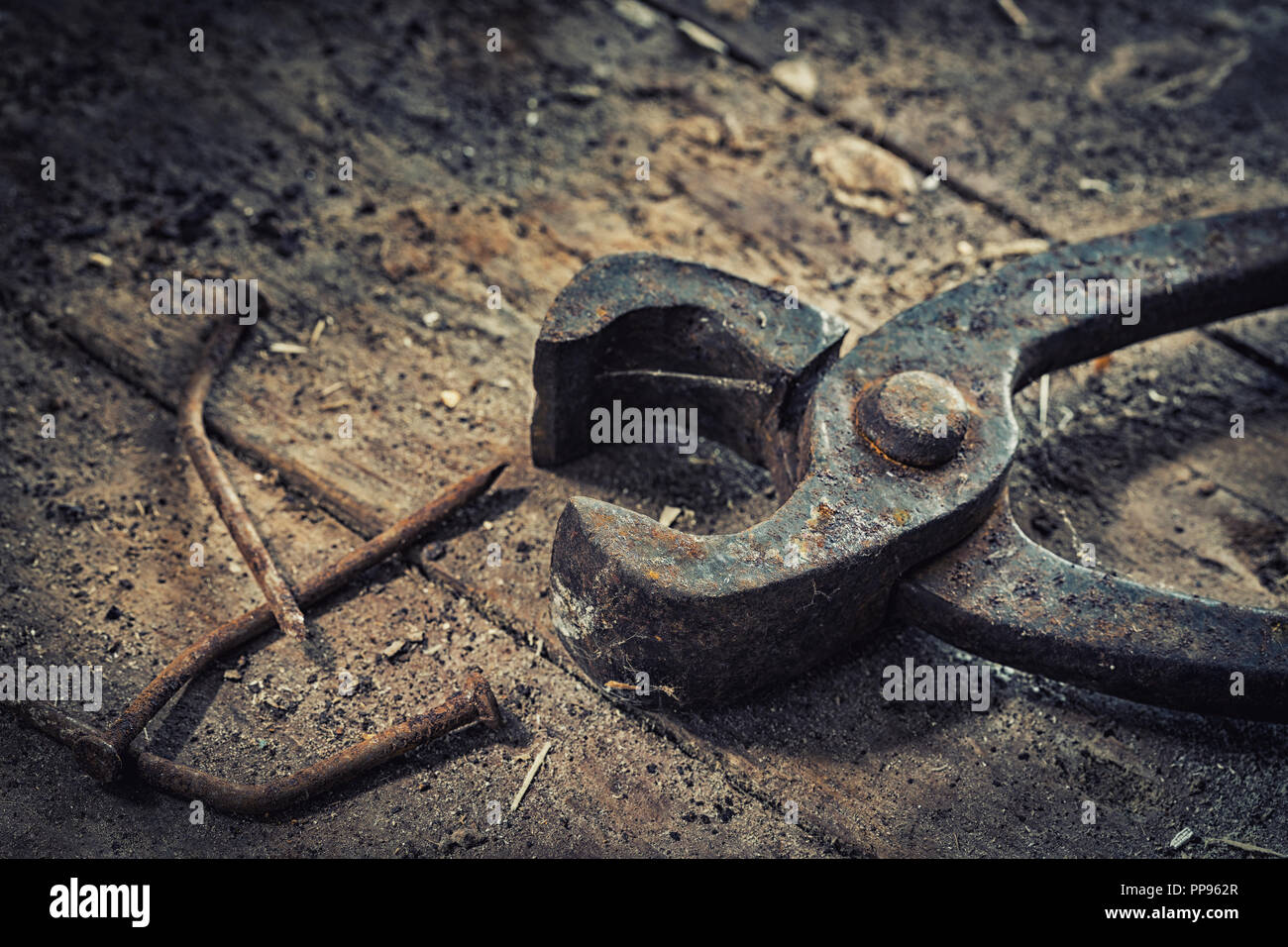 Old rusty tools in the workshop on an old wooden table Stock Photo