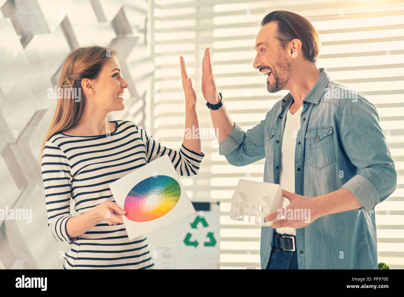 Joyful young people celebrating their successful project Stock Photo