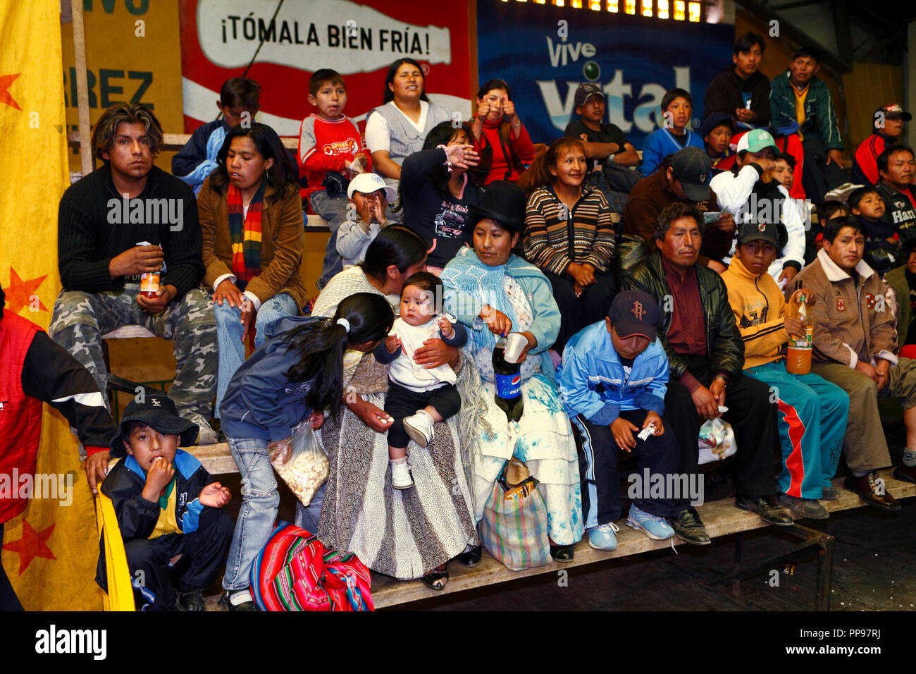 Spectators on the tribune are waiting for the wrestling matches in the multi-purpose sports hall Anden Secrets at the Plaza San Pedro in El Alto, above Bolivia's capital La Paz, where on every Sunday afternoon the quitting takes place with Cholita's wrestling. Stock Photo