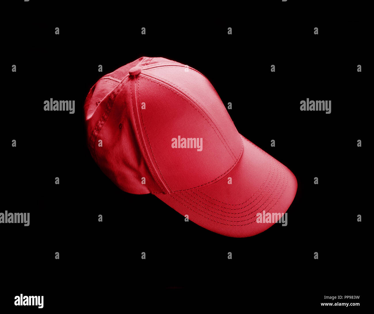 Red baseball cap on black background. Template for placing your design. Stock Photo