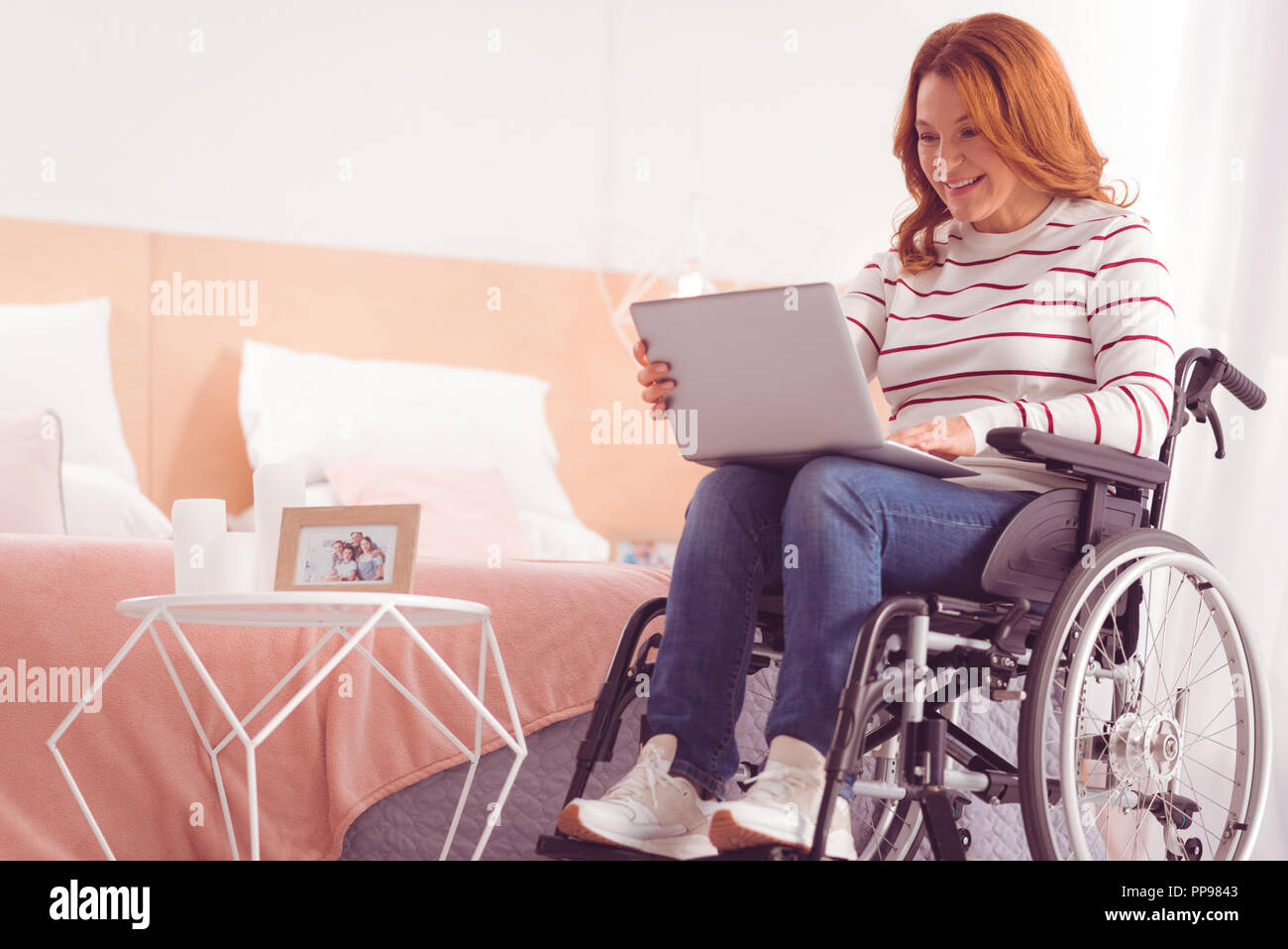 Positive disabled woman surfing the internet Stock Photo