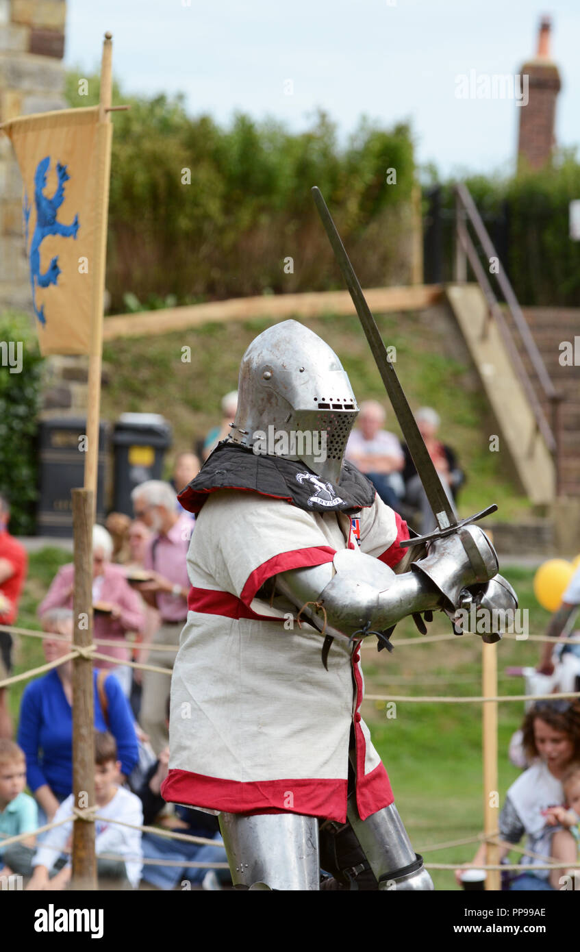 TONBRIDGE, ENGLAND - SEPTEMBER 9, 2018: Sword fighter wearing a St Georges Cross tunic over his steel body armour at a Medieval Fair at Tonbridge Cast Stock Photo