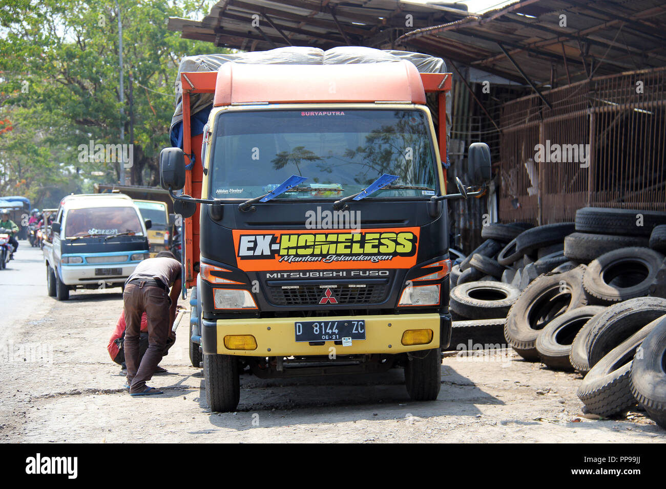 Truck drivers and workers checking tires in Bandung, Indonesia, Southeast  Asia Stock Photo - Alamy