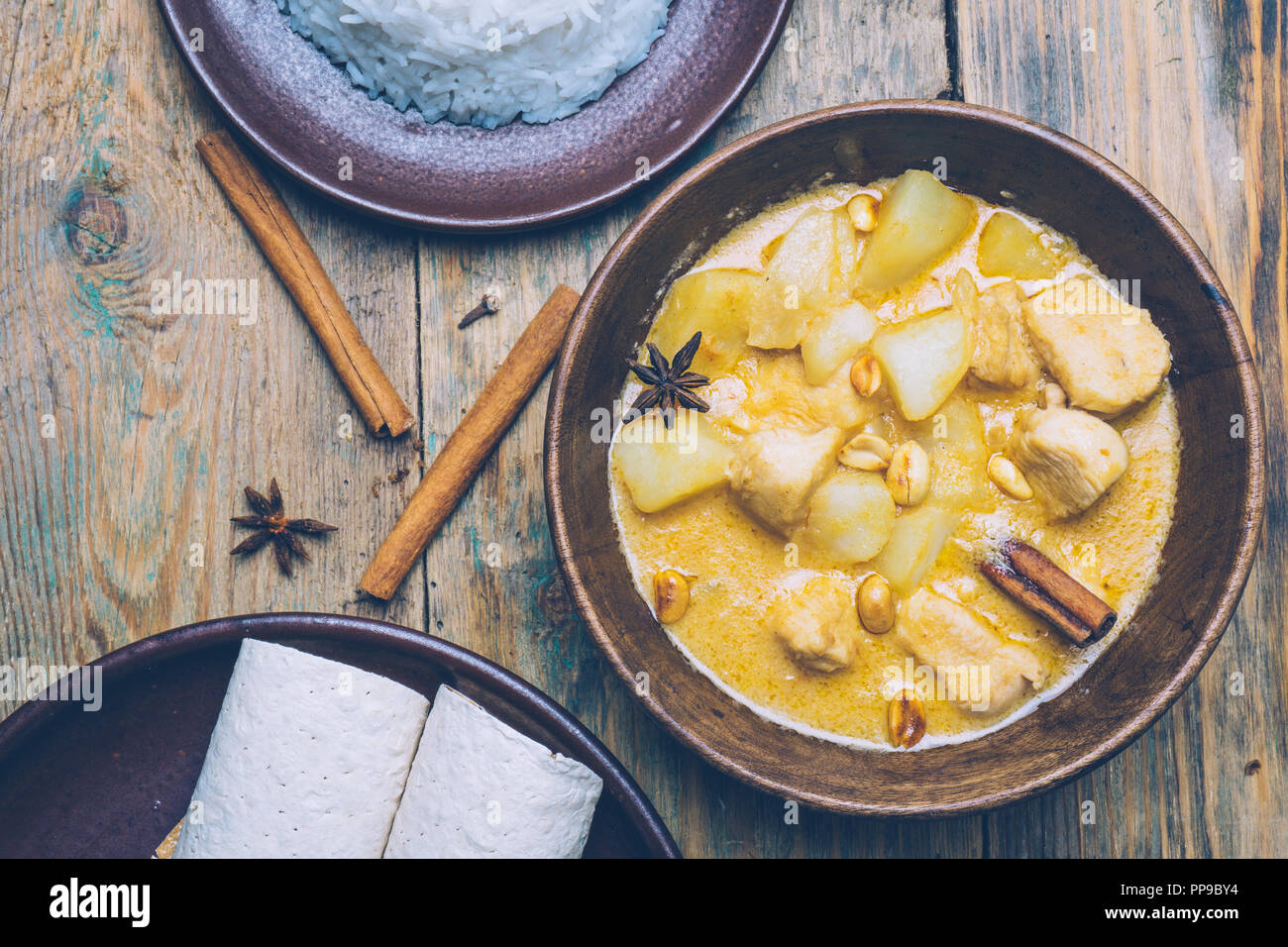 Thai massaman curry (chicken curry) with cinnamon sticks and plane riсe