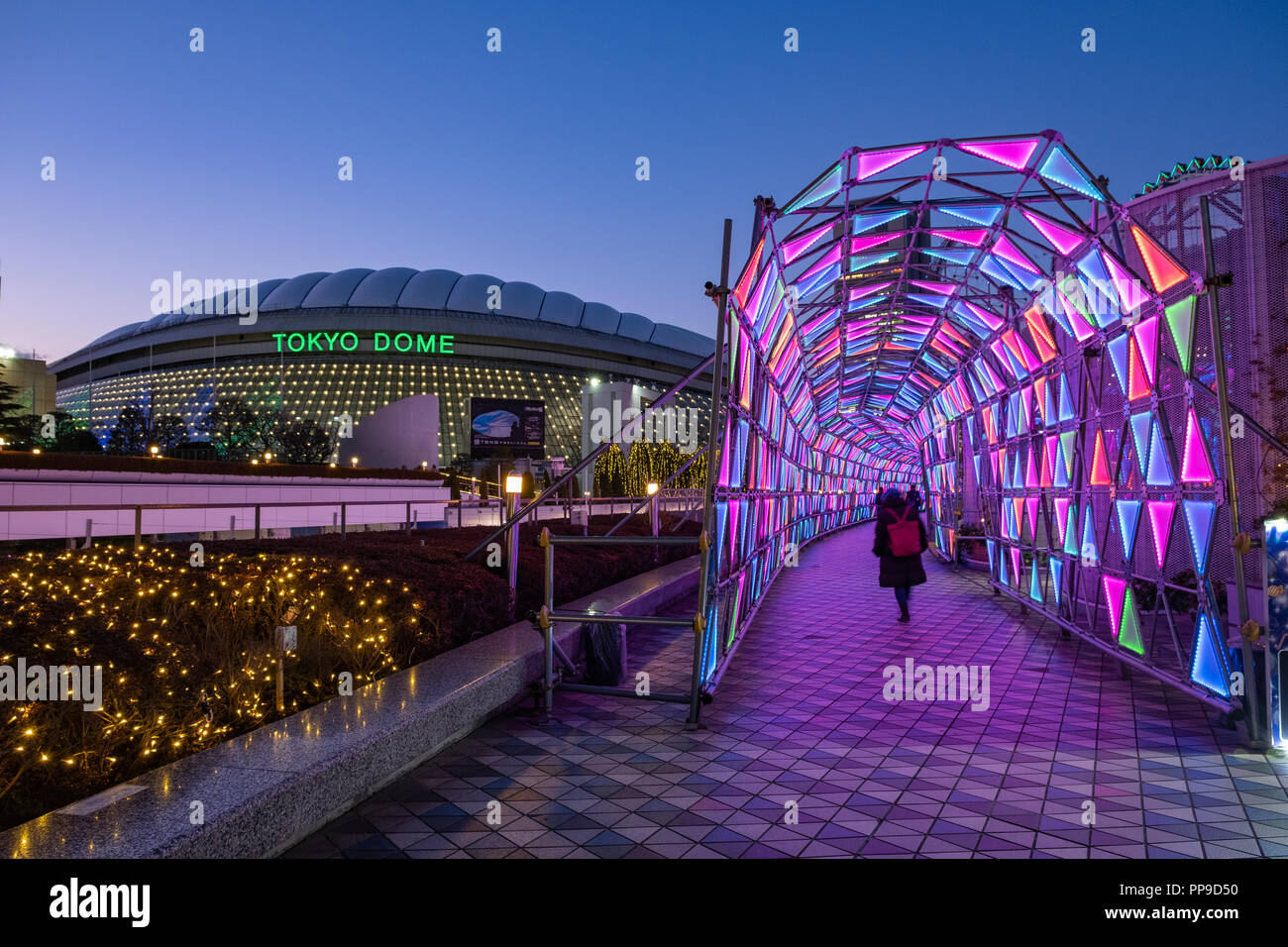 TOKYO, JAPAN - 13 FEB 2018: Tokyo Dome arena and neon light tunnel at blue hour Stock Photo