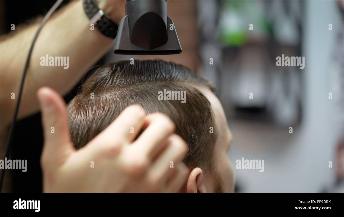 mens haircut in barbershop master barber does a haircut to the master barber