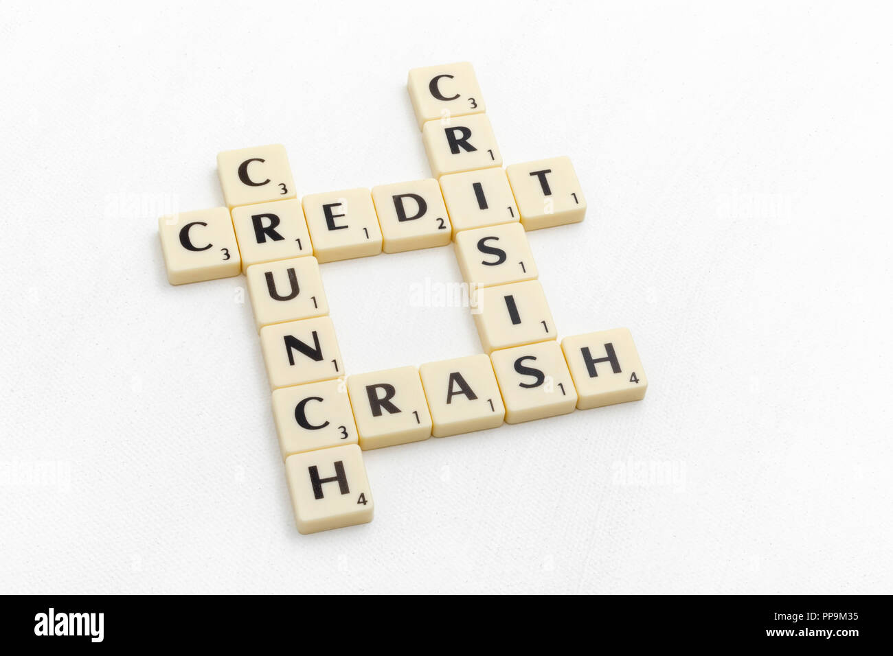 Letter tiles spelling out aspects of personal finances / financial management, financial crisis, running up bills, loan debts, SVB bank collapse. Stock Photo