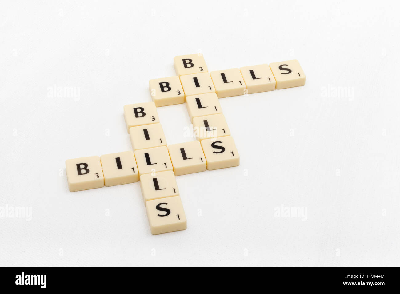 Letter tiles spelling out aspects of personal finances / financial management, financial crisis, running up bills, debts etc. Stock Photo