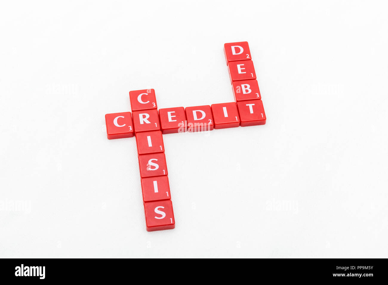 Letter tiles spelling out aspects of personal finances / financial management, financial crisis, running up bills, debts, personal loans etc. Stock Photo