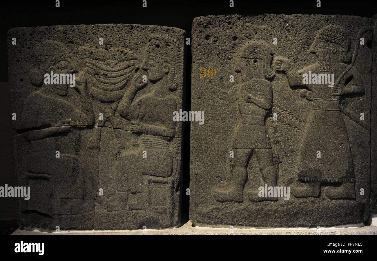 Orthostat with relief depicting a banquet (left) and males walking (right). 9th century BC. Basalt. Late Hitite Period. From the west side of citadel gate, Sam'al (Sinjerli). Archaeological Museum. Museum of Ancient Orient. Istanbul. Turkey. Stock Photo