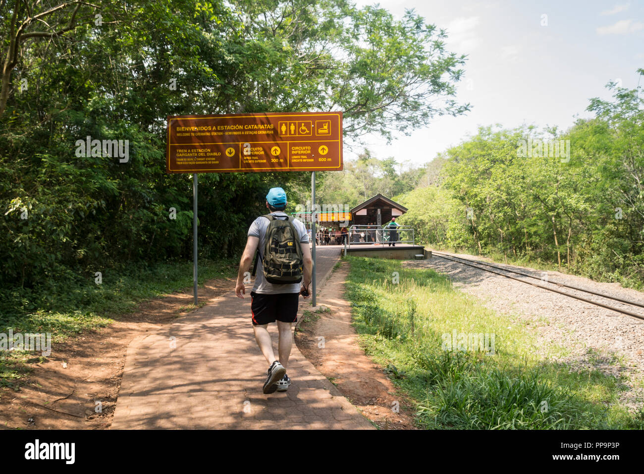 A tourist walking into train station at Iguazu National Park, Argentina, South America Stock Photo