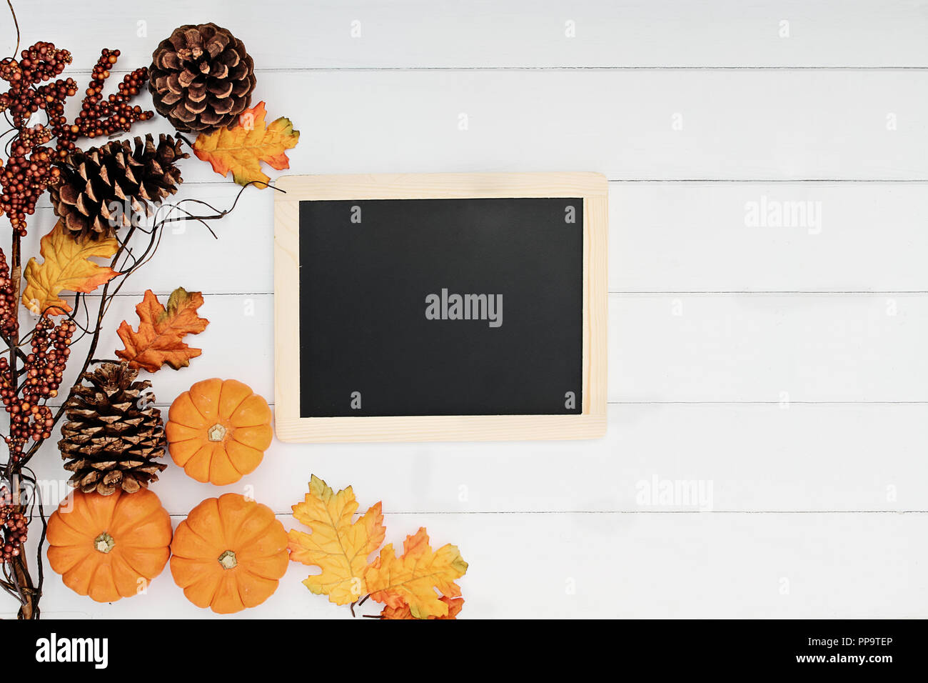 Rustic fall background of autumn leaves, pine cones and mini pumpkins ...