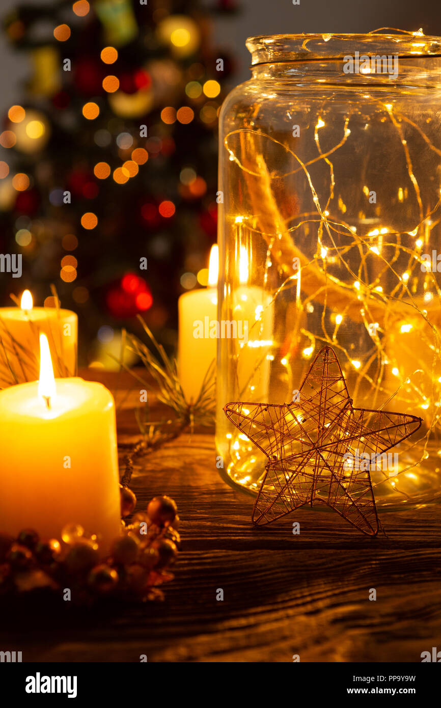 Christmas electric garland in a glass jar with candles Stock Photo - Alamy