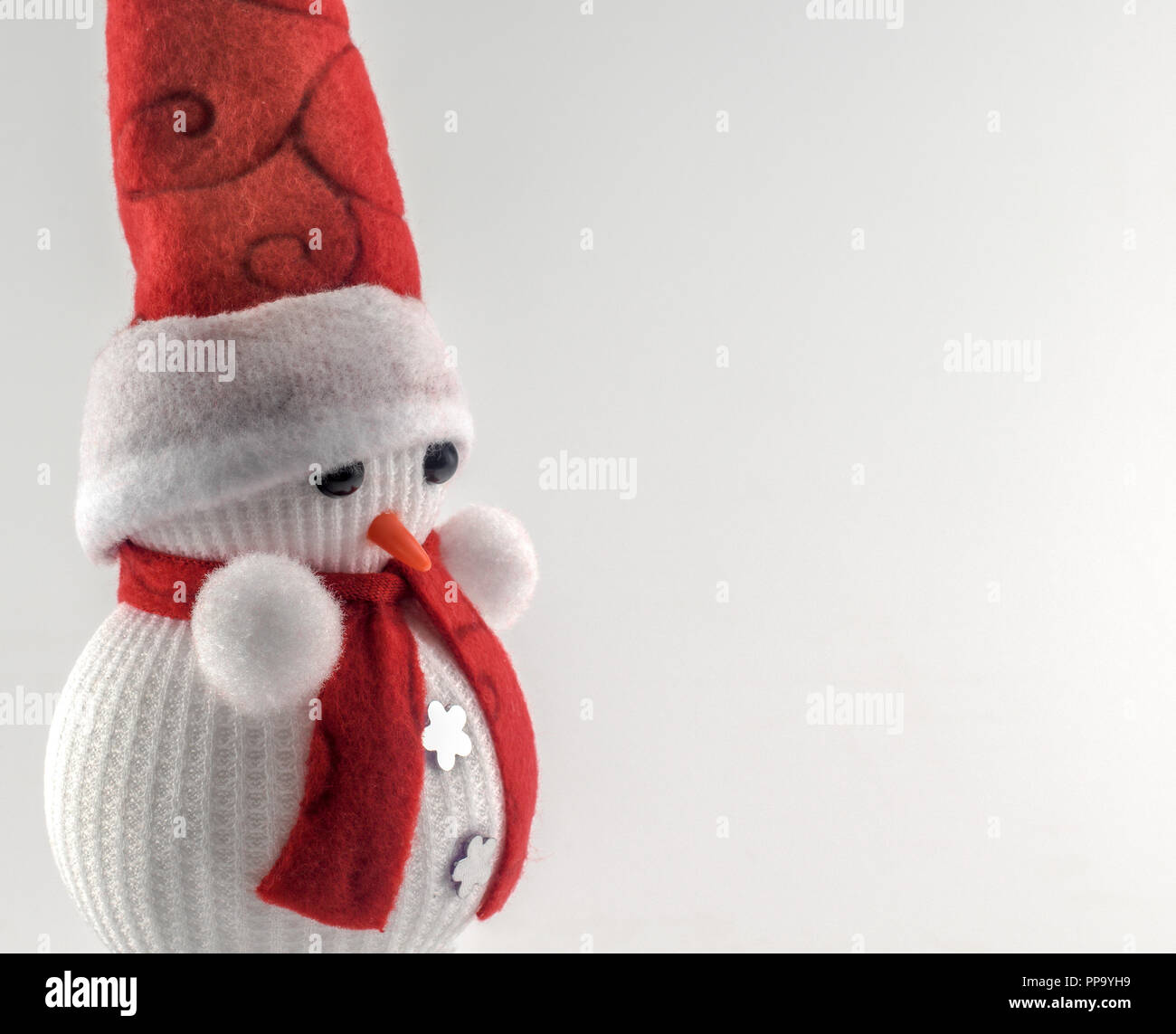 Snowman christmas ornament with Santa Claus hat and red scarf isolated ...