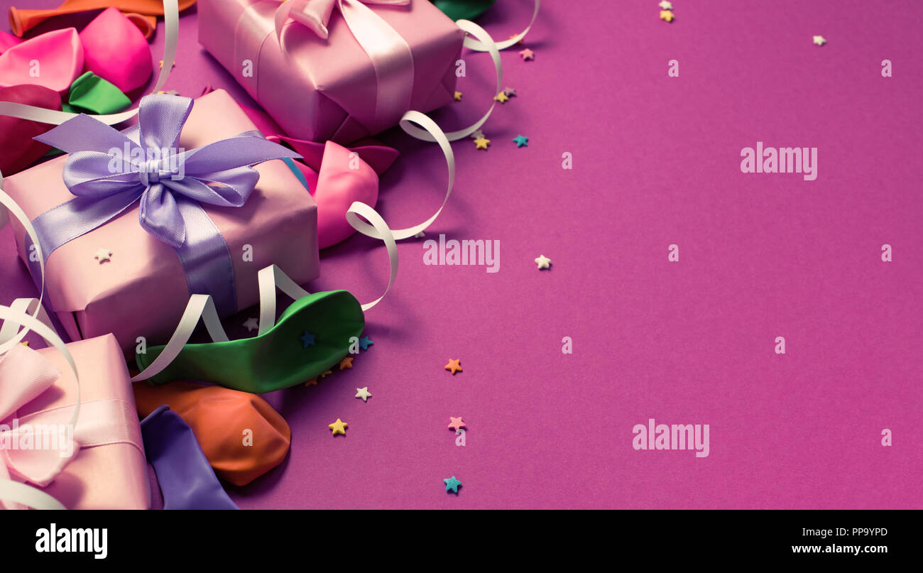 Banner Festive background of purple material colorful balloons streamers confetti. Top view flat lay copy space Stock Photo