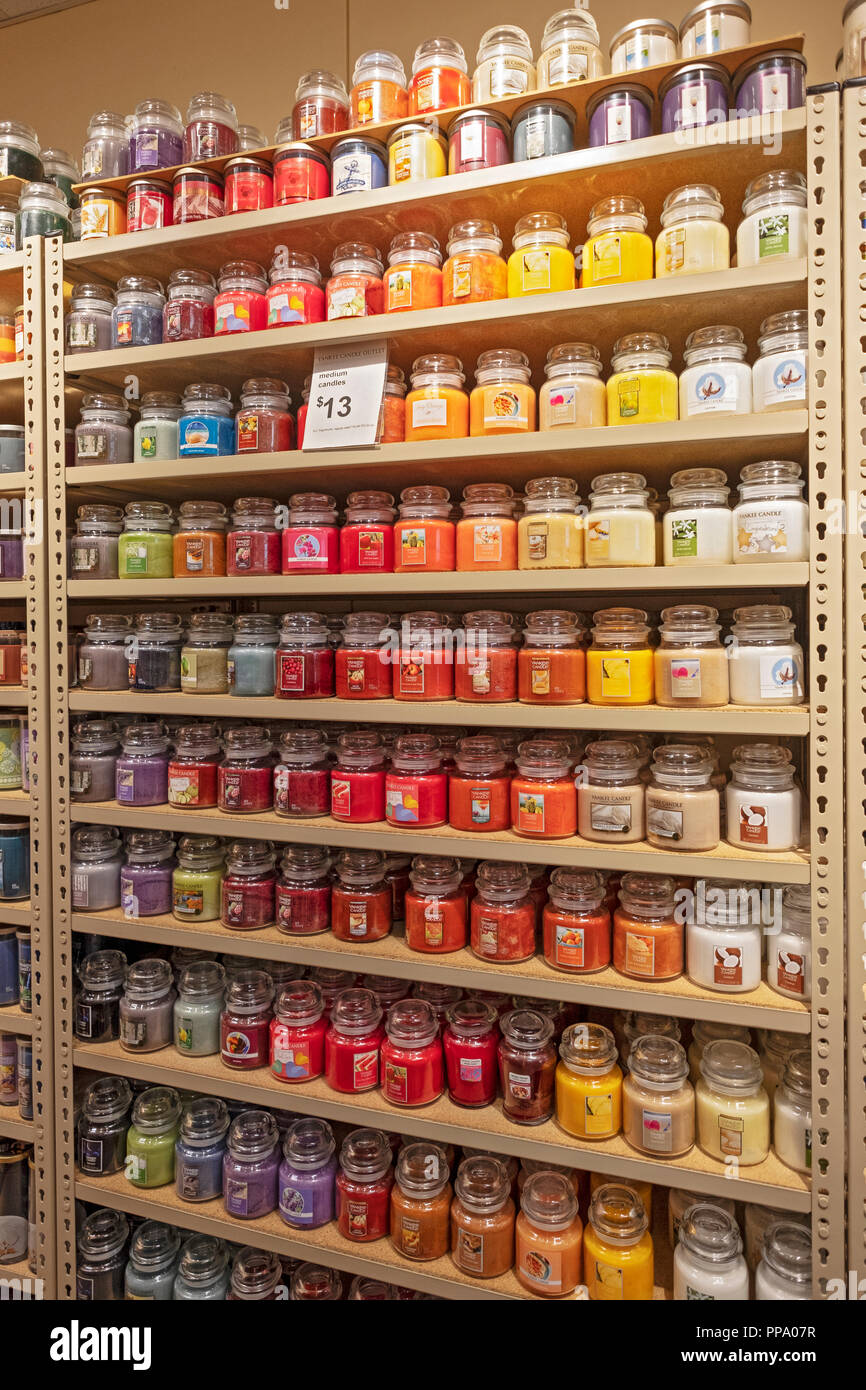 Shelves with jars of YANKEE CANDLES for sale at a Yankee Candle store in the Deer Park, Long Island Tanger Outlet mall. Stock Photo
