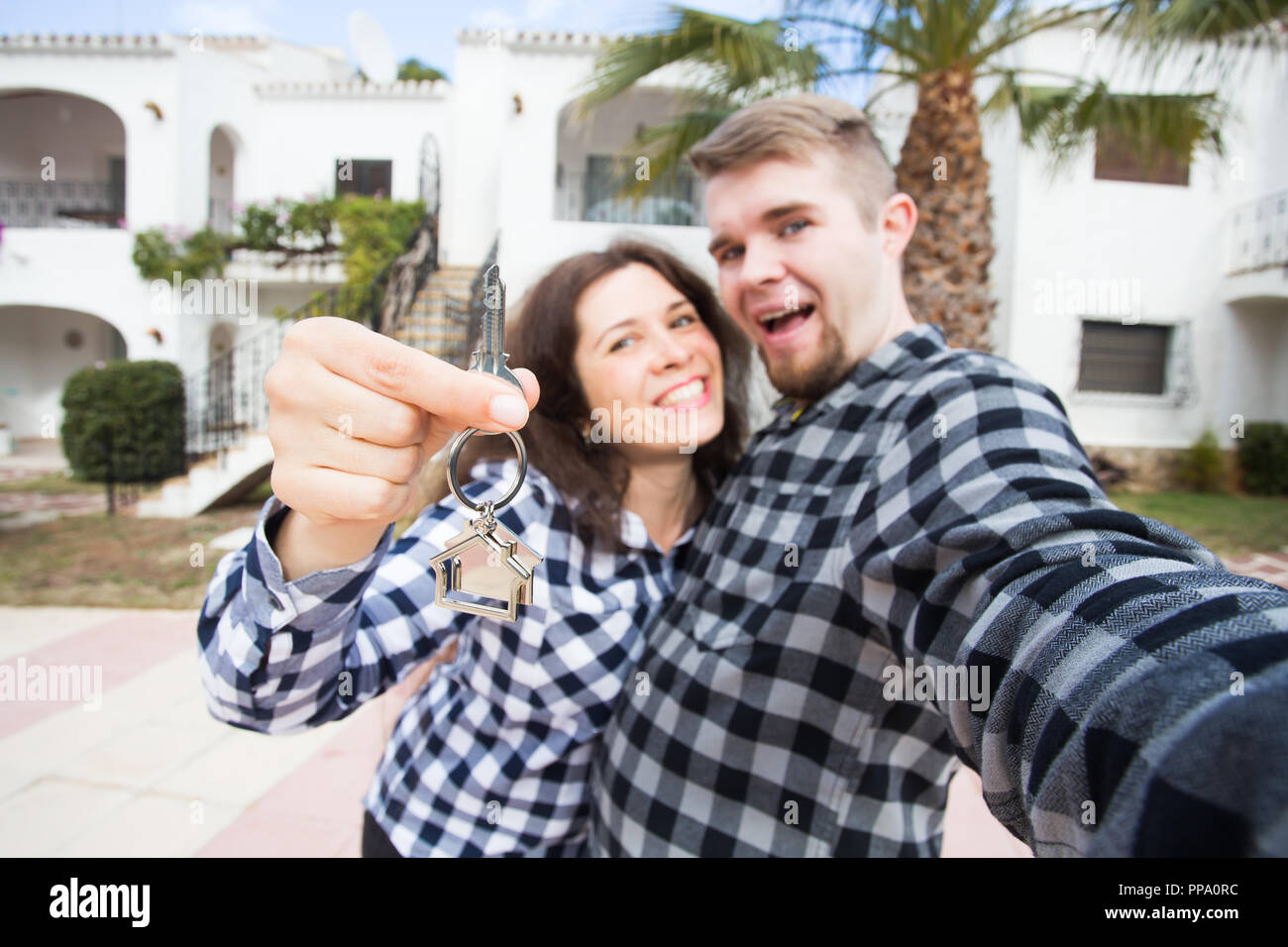 Real estate - happy couple showing keys of their new house Stock Photo ...