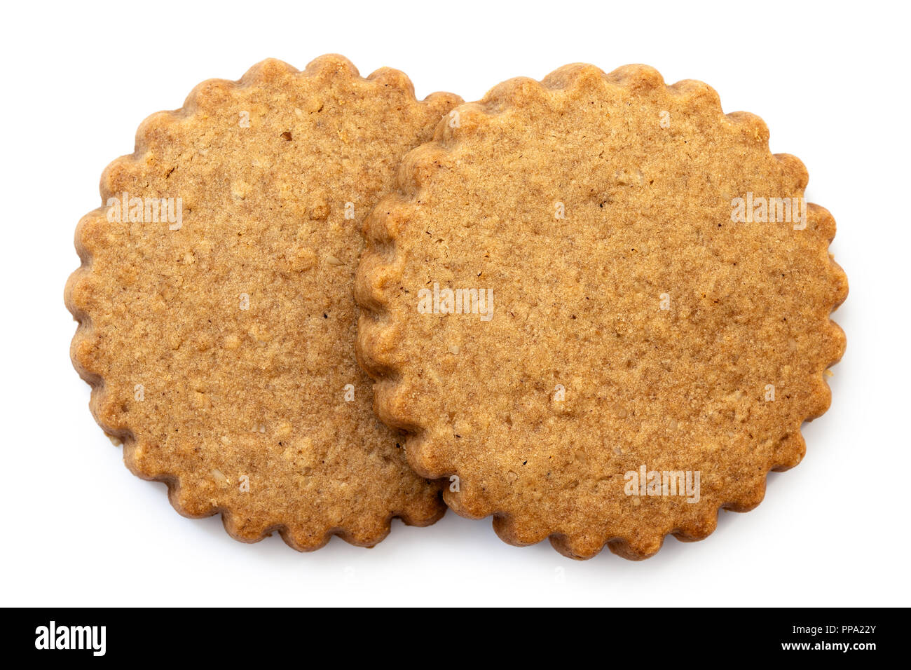 Two round gingerbread biscuits isolated on white from above. Serrated edge. Stock Photo