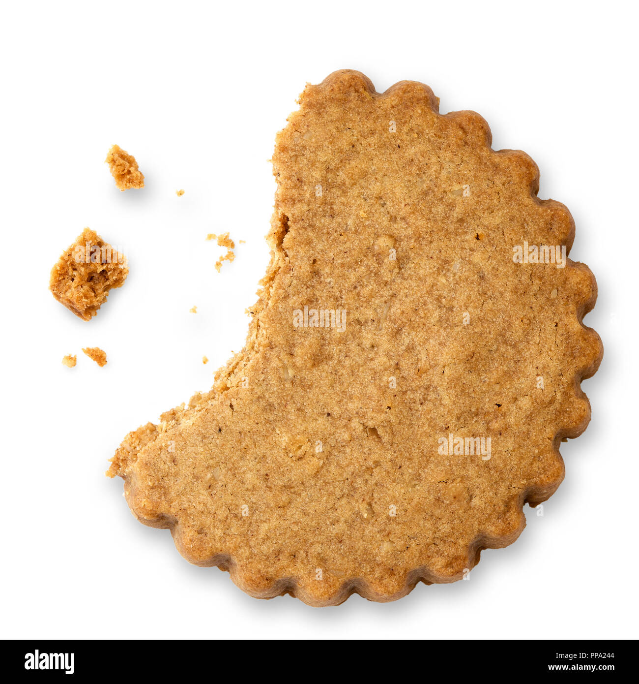 Partially eaten round gingerbread biscuit isolated on white from above. Serrated edge. Stock Photo