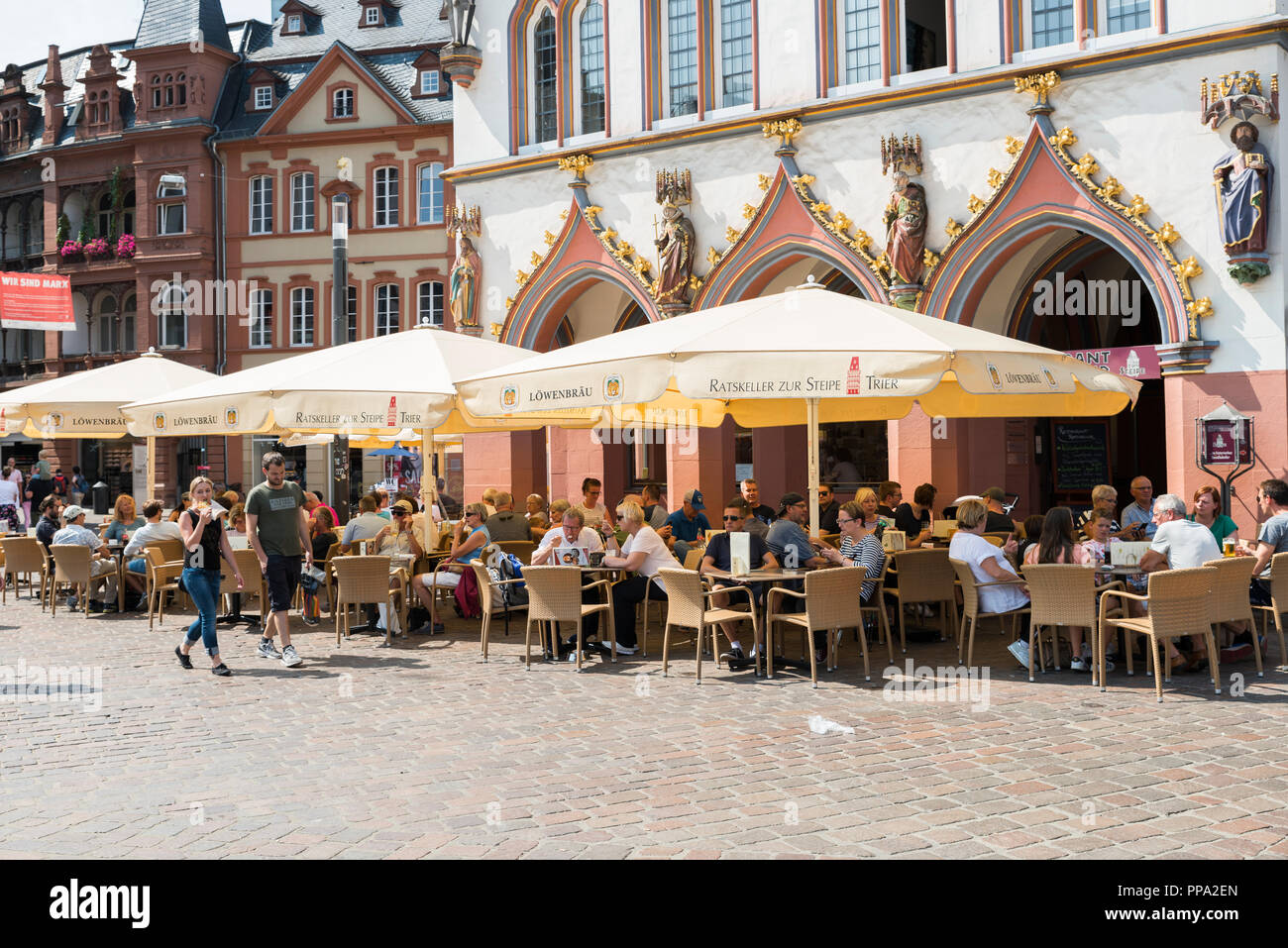 Trier,Germany,17-aug-2018:people on terrace in the main street of Trrier in Germany,The first traces of human settlement in the area of the city show evidence of linear pottery settlements dating from the early Neolithic period Stock Photo