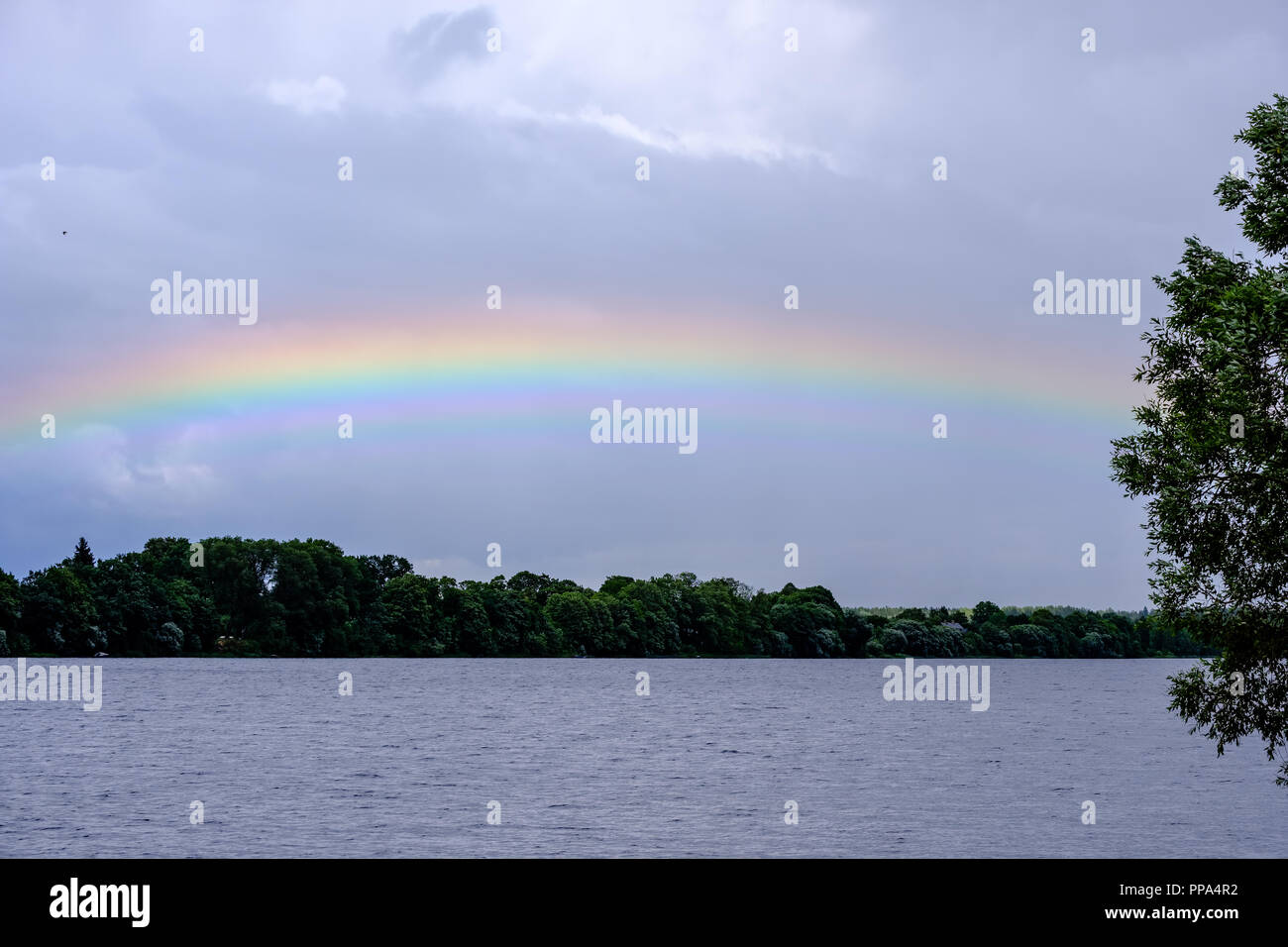 rainbow over the country fields on a stormy clouded sky Stock Photo - Alamy