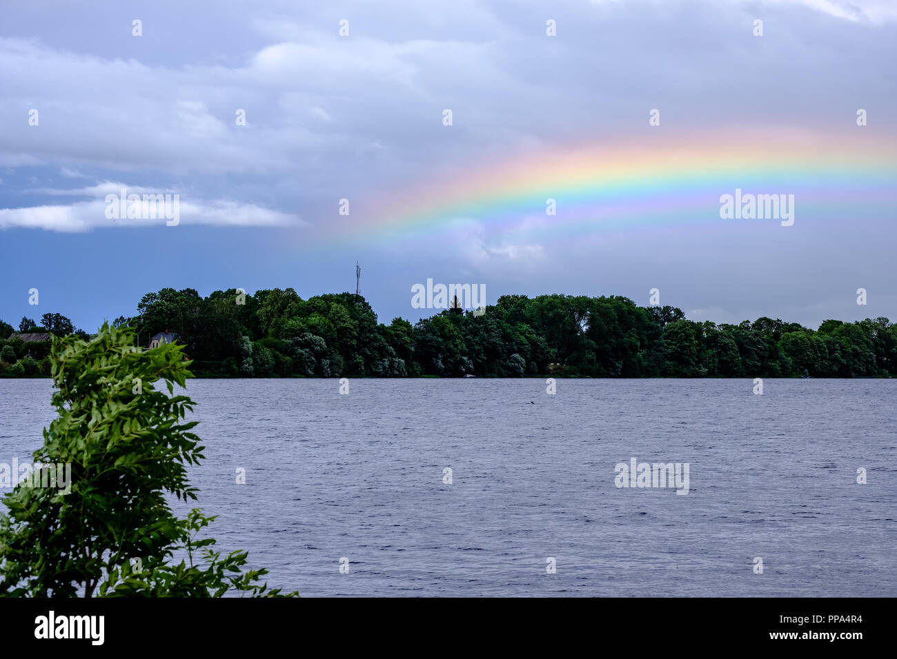 rainbow over the country fields on a stormy clouded sky Stock Photo - Alamy