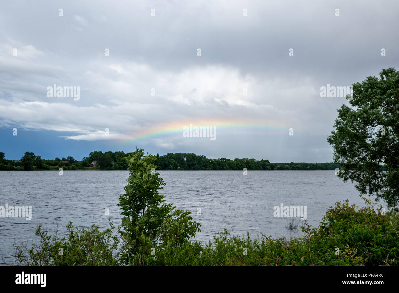 rainbow over the country fields on a stormy clouded sky Stock Photo - Alamy