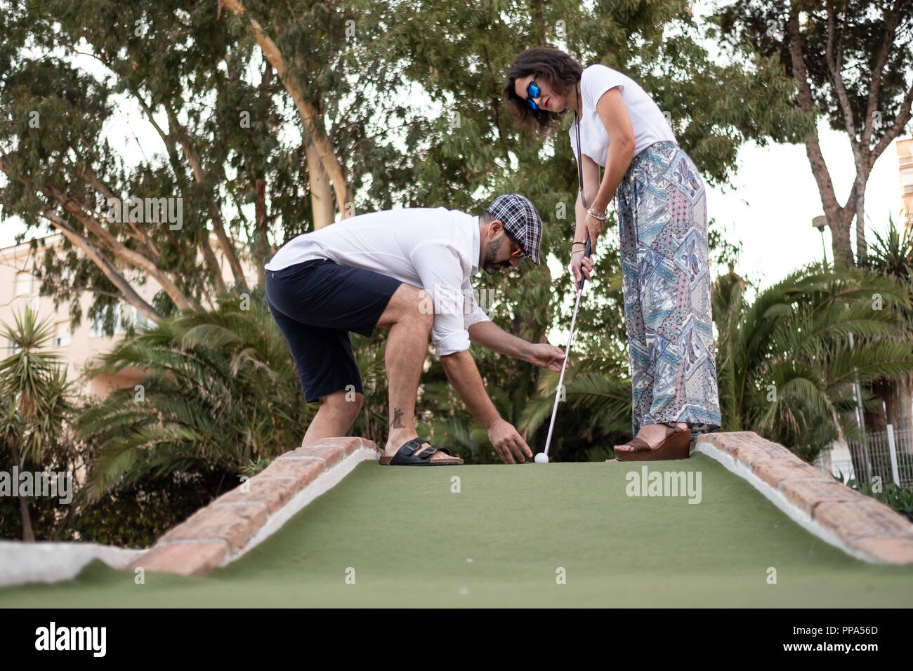 man giving golf lesson to woman Stock Photo