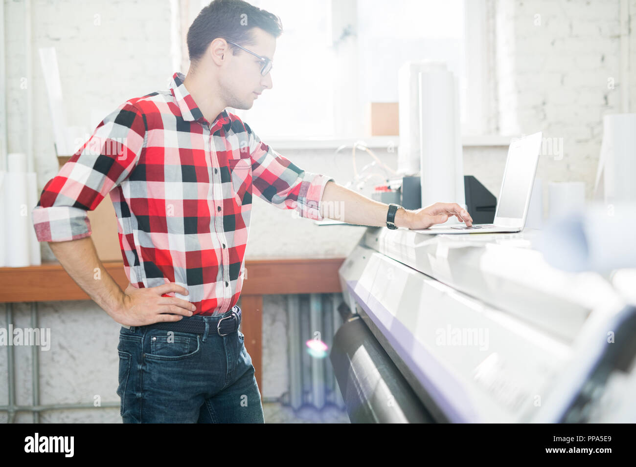 Man using laptop in publishing office Stock Photo