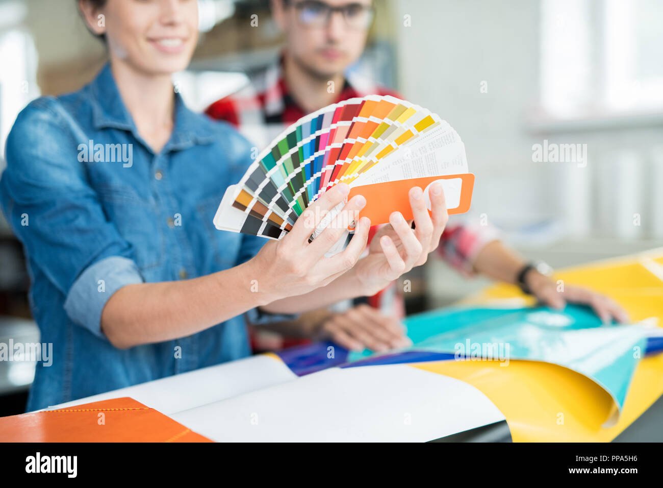 Crop coworking designers choosing colors Stock Photo