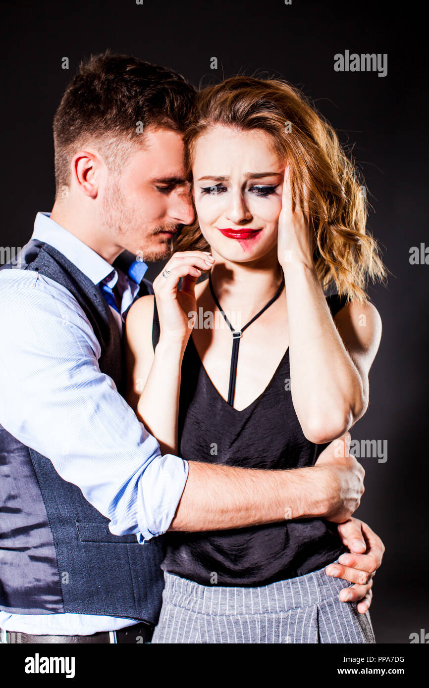 Attractive young woman crying in her partner's arms Stock Photo - Alamy