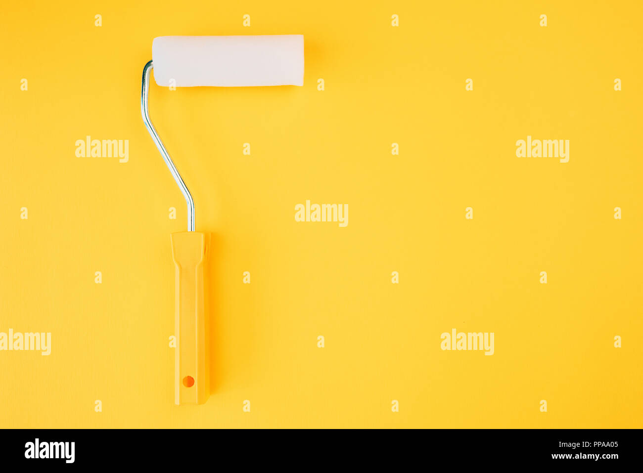 Paint roller for wall painting in vivid warm colors Stock Photo
