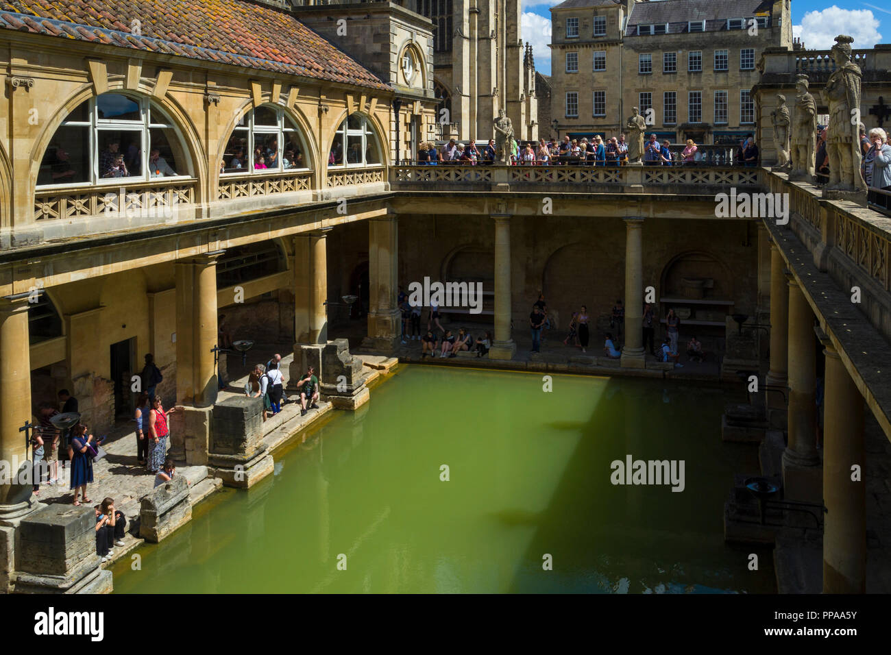 Visitors exploring the Terrace and Great Bath of the Roman Baths, in