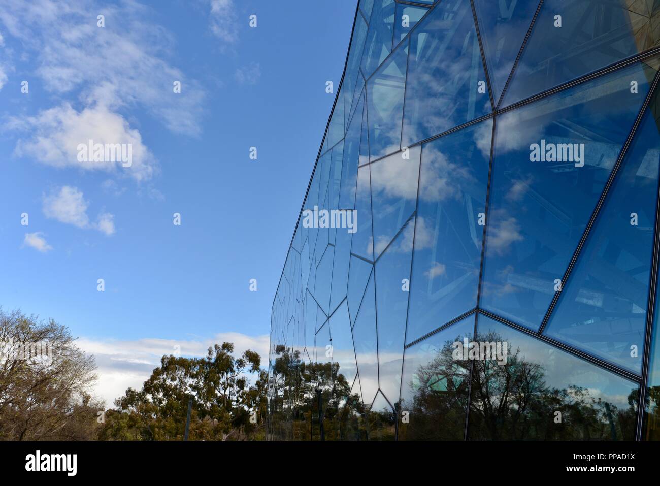 Glass panels reflecting a scene, The Australian centre for the moving image, museum, Melbourne VIC, Australia Stock Photo