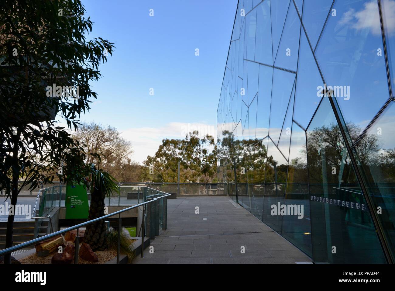 Glass panels reflecting a scene, The Australian centre for the moving image, museum, Melbourne VIC, Australia Stock Photo