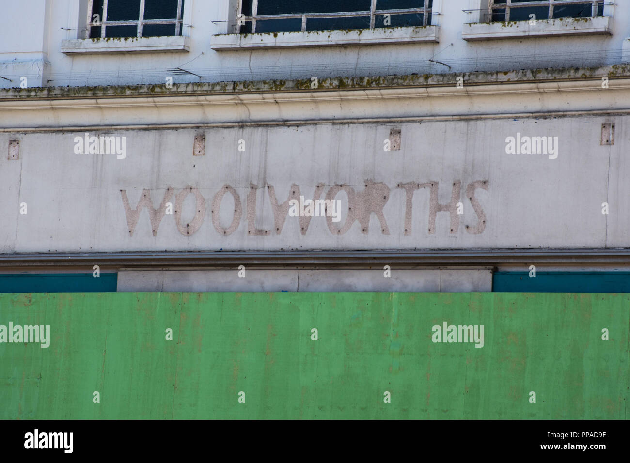 Empty closed down boarded up Woolworths shop, UK Stock Photo